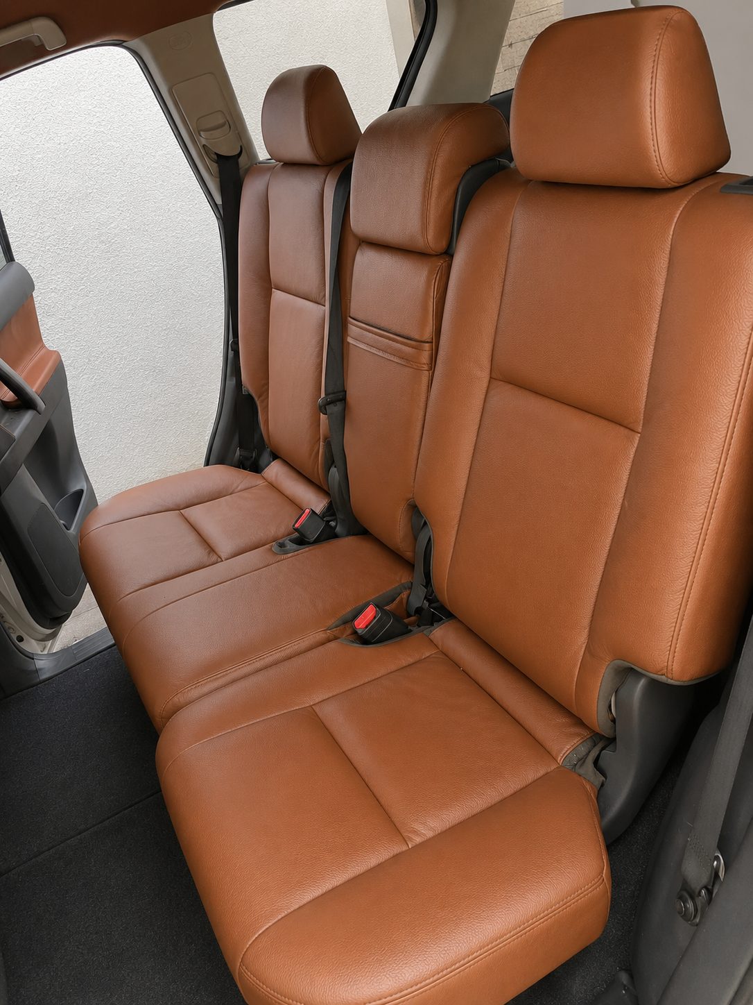 Rebuilt brown leather rear bench refitted to the vehicle