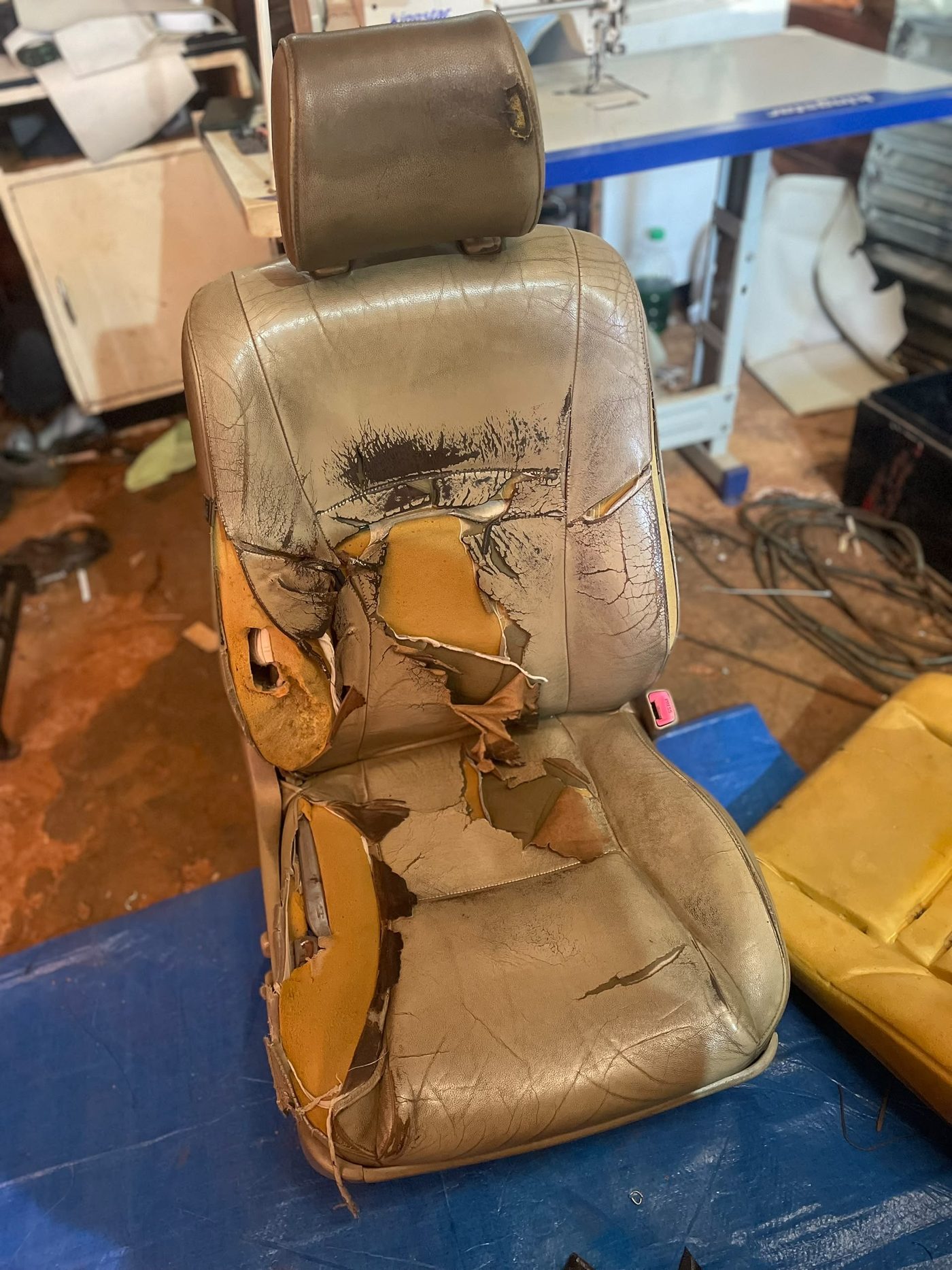 Perished seat with torn covers and exposed foam