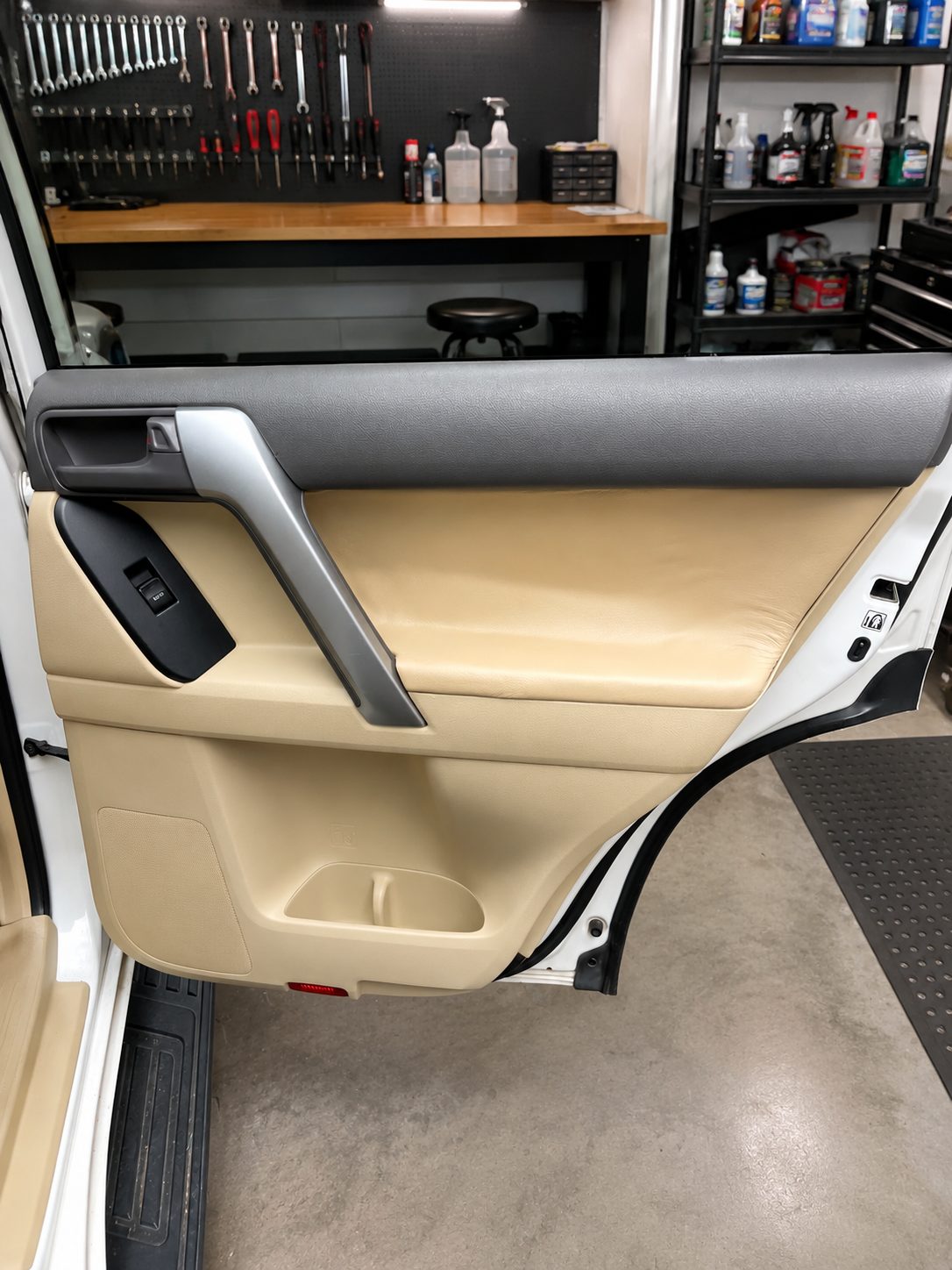 Beige leather door panel refitted to a Prado