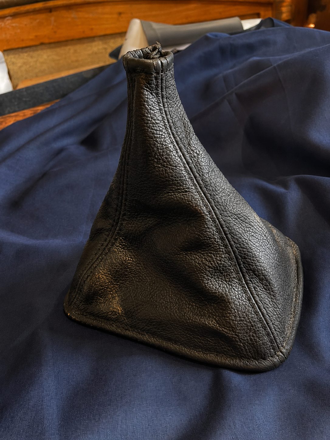 Hand-stitched black leather gear shift boot