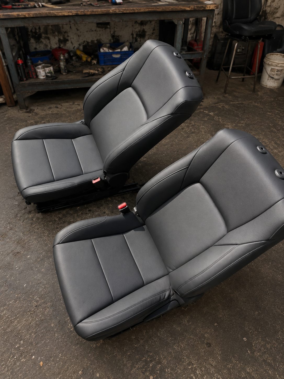 Grey and black leather seat pair after rebuild