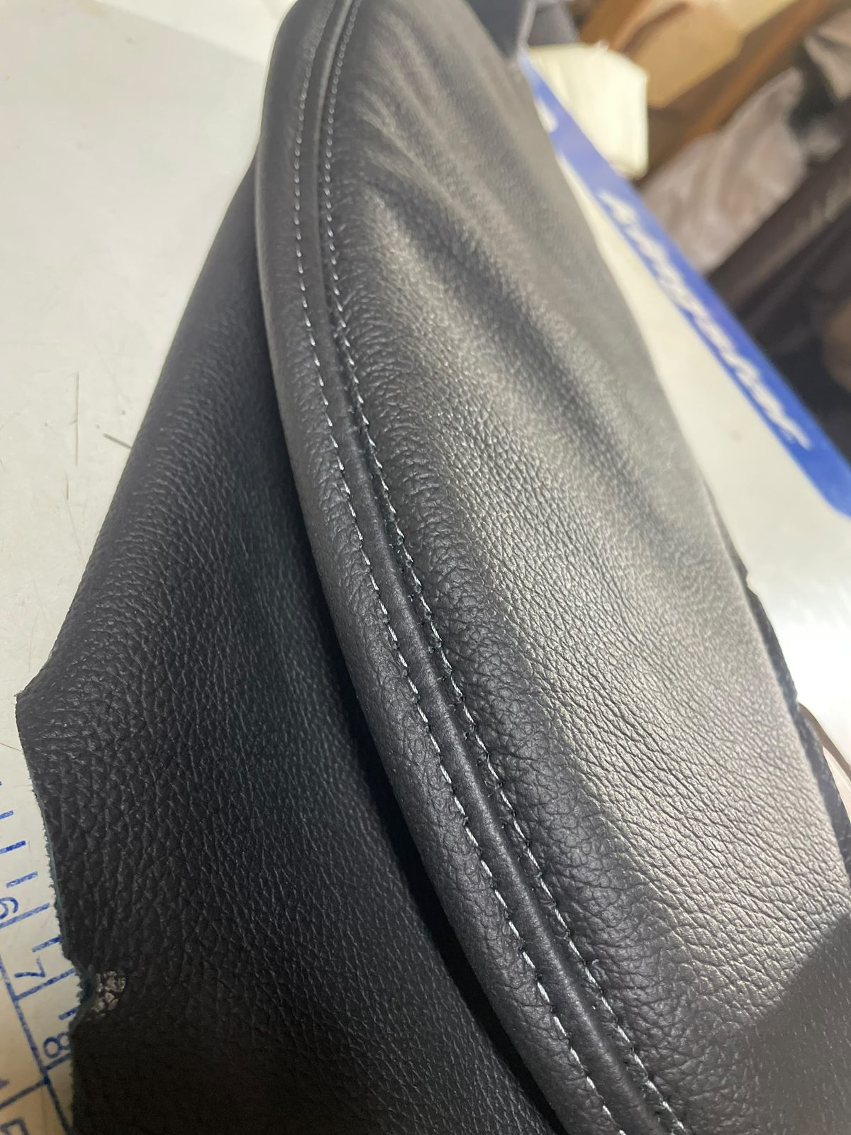 Twin-needle stitching on black leather trim